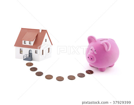 Piggy bank with coins and house miniature. 37929399