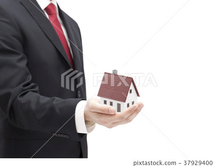 Businessman with house miniature in hand isolated  37929400