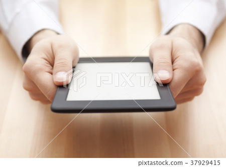 Tablet or e-book reader on wood background  37929415