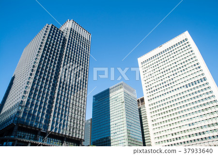 Skyscrapers near Tokyo Station under blue sky Skyscrapers near Tokyo Station under blue sky 37933640