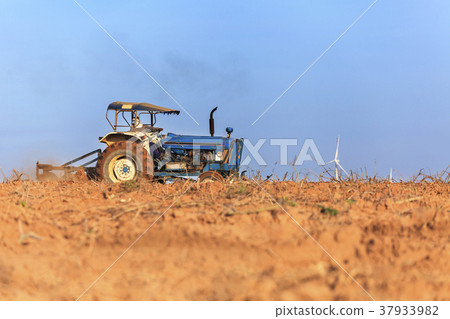 Farmer in tractor preparing farmland 37933982