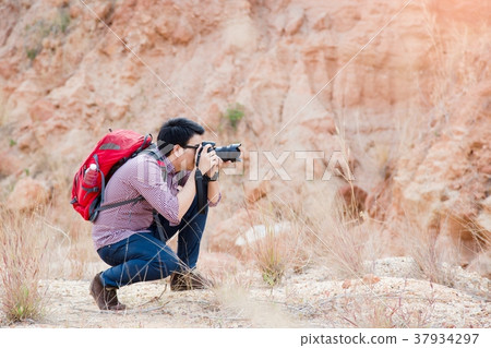 Young photographer travel red backpack Young photographer travel red backpack 37934297