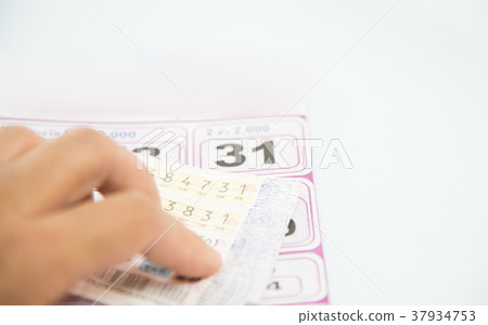 Checking thai lottery on white background. Checking thai lottery on white background. 37934753