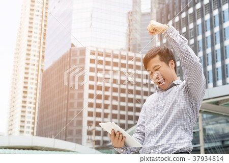 investor young businessman standing using a laptop investor young businessman standing using a laptop 37934814