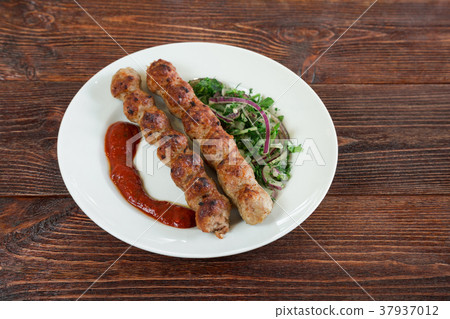 Portion luleh kebab on a plate.  37937012