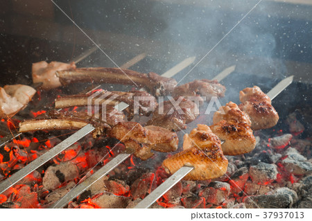 Appetizing meat grilled on skewers. Appetizing meat grilled on skewers. 37937013