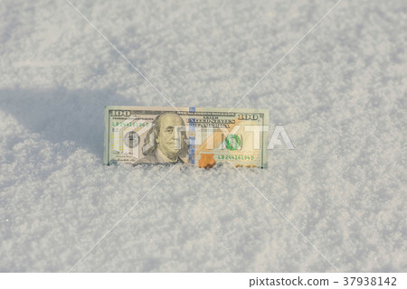 Banknote of a hundred US dollars in the snowdrift Banknote of a hundred US dollars in the snowdrift 37938142