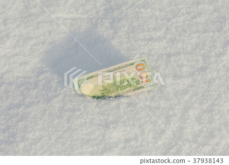 Banknote of a hundred US dollars in the snowdrift  37938143