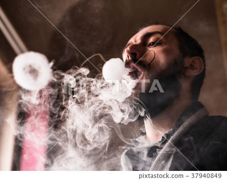 Man with Beard and Mustages Vaping an Electronic Man with Beard and Mustages Vaping an Electronic 37940849