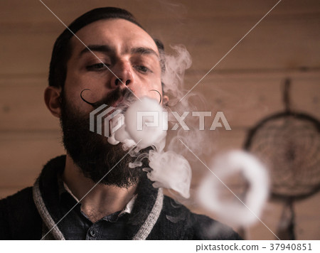 Man with Beard and Mustages Vaping an Electronic Man with Beard and Mustages Vaping an Electronic 37940851