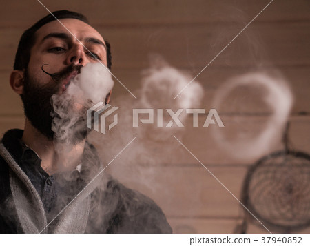 Man with Beard and Mustages Vaping an Electronic Man with Beard and Mustages Vaping an Electronic 37940852