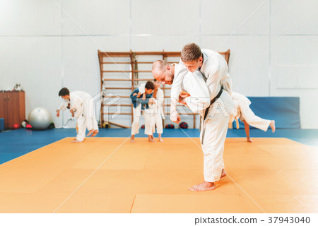 Kid judo, young fighters on training in hall Kid judo, young fighters on training in hall 37943040