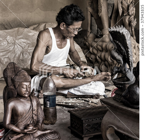 A man is making wooden crafts in Indonesia A man is making wooden crafts in Indonesia 37943835