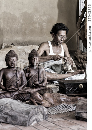 A man is making wooden crafts  in Indonesia 37943836