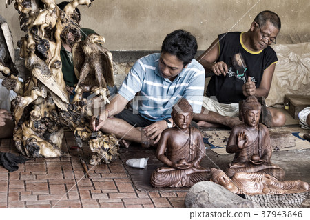 Men are making wooden crafts  in Indonesia 37943846