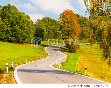 Winding asphalt road in rural landscape of Sumava Winding asphalt road in rural landscape of Sumava 37944264