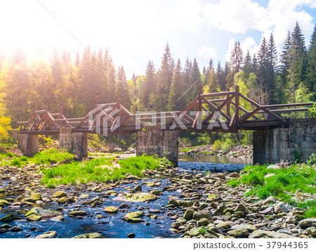 Wooden Soumarsky bridge over Vydra mountain river Wooden Soumarsky bridge over Vydra mountain river 37944365