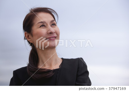 Senior lady cloudy sky 37947169