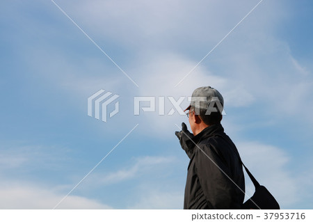 Senior man with blue sky in winter Senior man with blue sky in winter 37953716