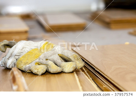 Pair of used gloves lying on removed laminate 37957574