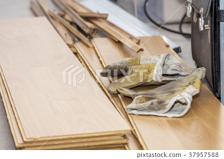 Pair of used gloves lying on removed laminate 37957588