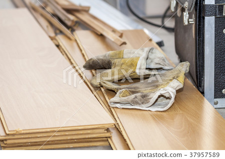 Pair of used gloves lying on removed laminate 37957589