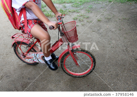 A boy wearing a school uniform with old bicycle A boy wearing a school uniform with old bicycle 37958146