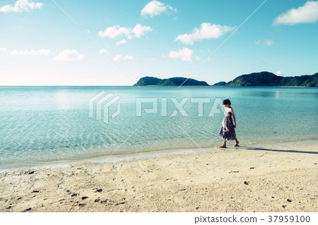 走在一個海灘的婦女在沖繩島 走在一個海灘的婦女在沖繩島 37959100