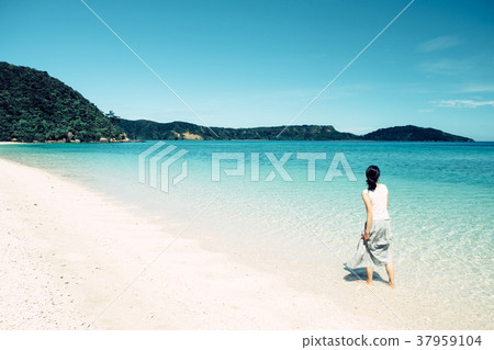 Woman walking on a beach in Okinawa 37959104