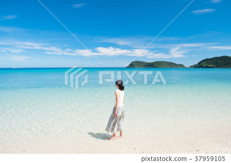 Woman walking on a beach in Okinawa Woman walking on a beach in Okinawa 37959105