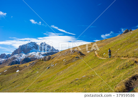 Hiker walking on a colorful valley Hiker walking on a colorful valley 37959586