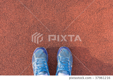 Blue shoes on the orange background. 37961216