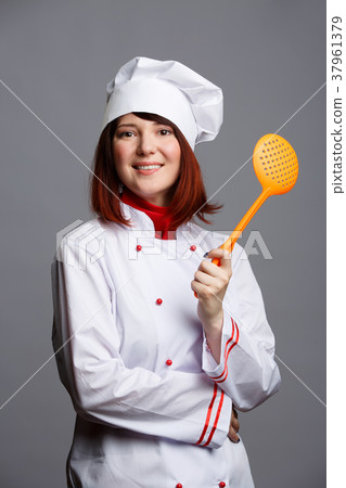 Photo brunette cook in white dressing gown and cap Photo brunette cook in white dressing gown and cap 37961379