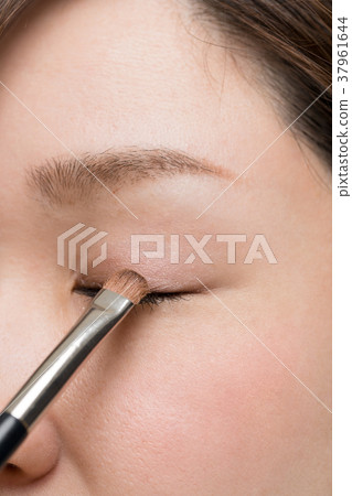 Woman doing makeup, eye shadow, palette, compact Woman doing makeup, eye shadow, palette, compact 37961644