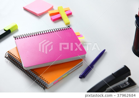 Colorful notebooks and office supplies on table. Colorful notebooks and office supplies on table. 37962684
