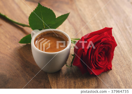 fresh espresso with red rose flower on wood table fresh espresso with red rose flower on wood table 37964735