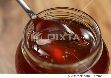 organic honey drips from spoon in jar organic honey drips from spoon in jar 37965060