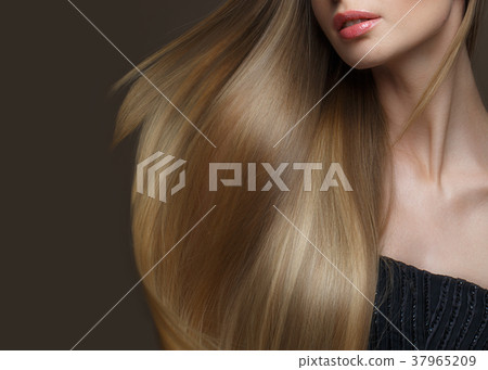 Beautiful blond girl with a perfectly smooth hair Beautiful blond girl with a perfectly smooth hair 37965209