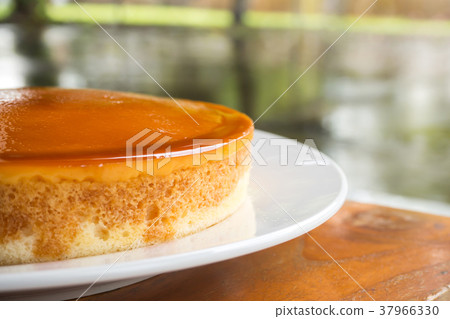 Caramel custard cake on white plate. Sweet dessert 37966330