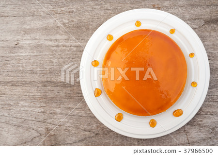 Caramel custard cake on white plate. Top view. Caramel custard cake on white plate. Top view. 37966500