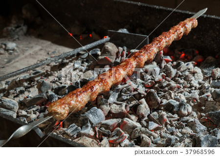 Appetizing lula kebab grilled on metal skewer. Appetizing lula kebab grilled on metal skewer. 37968596