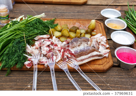 Salted pork lard salo with onion on a wooden board Salted pork lard salo with onion on a wooden board 37969631