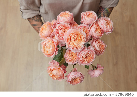 Woman with a bouquet of roses media 37969840