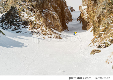 A man a snowboarder freerider descends a 37969846