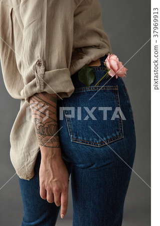 Young woman with rose media in her pocket. Young woman with rose media in her pocket. 37969913