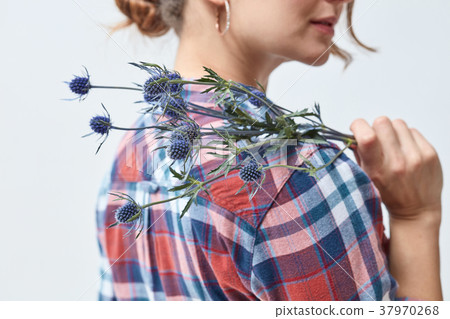 Young girl with flowers eryngium 37970268