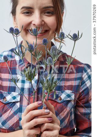 Young girl with flowers eryngium 37970269