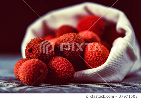 Lychee fruit in white sack close Lychee fruit in white sack close 37971508