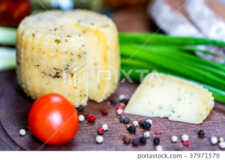 Rustic cheese with herbs, pepper and vegetables Rustic cheese with herbs, pepper and vegetables 37971579