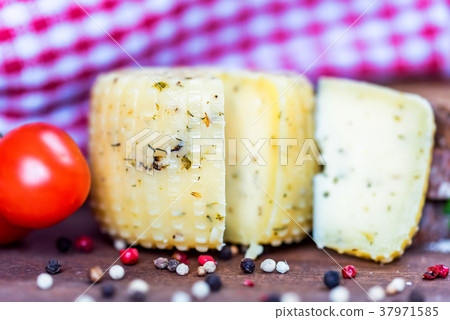 Rustic cheese with herbs, pepper and tomatoes Rustic cheese with herbs, pepper and tomatoes 37971585